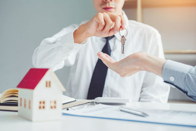 Midsection of man working on table