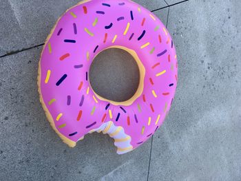 High angle view of pink inflatable donut on footpath