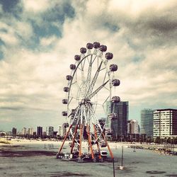 Ferris wheel against cloudy sky