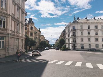 Vehicles on road along buildings