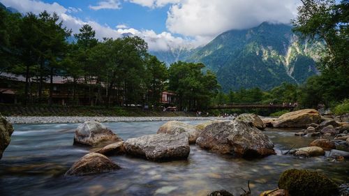 Scenic view of river and trees against sky