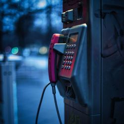 Close-up of telephone booth in city