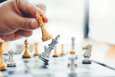 Close-up of hand holding chess pieces