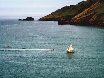 Sailboat sailing on sea against sky