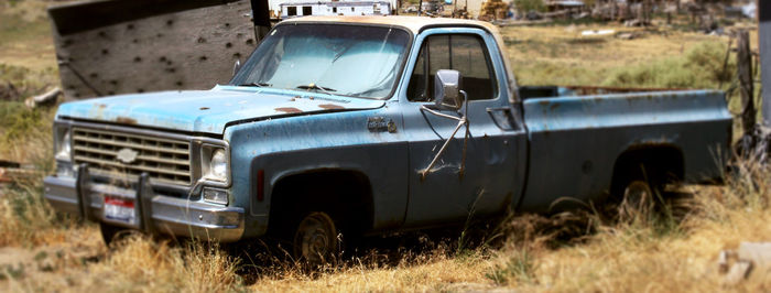 Abandoned car on field