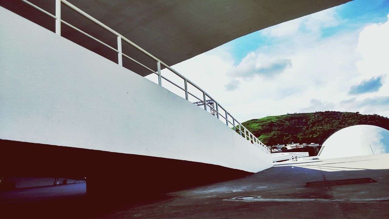 architecture, built structure, sky, low angle view, building exterior, bridge - man made structure, cloud - sky, connection, railing, engineering, transportation, day, no people, building, metal, cloud, outdoors, arch, architectural feature, staircase