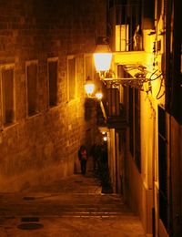 Man walking in illuminated city at night