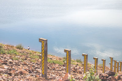 High angle view of wooden posts on beach