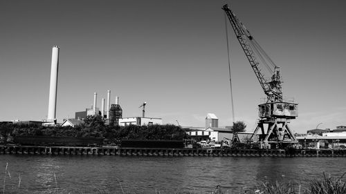 Cranes against clear sky