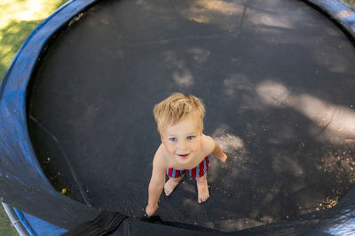 High angle portrait of cute boy in water