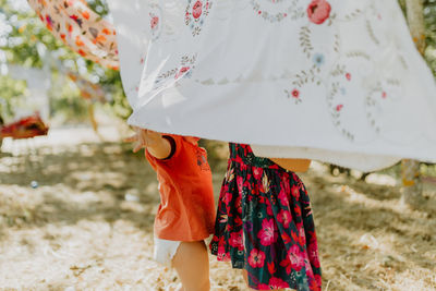 Children playing with hanging clothes