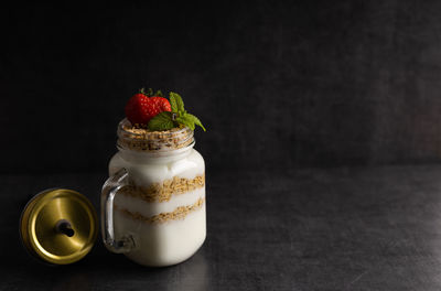 Close-up of fruits in glass jar on table