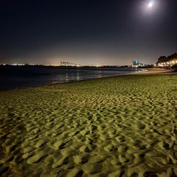 Scenic view of sea against clear sky at night