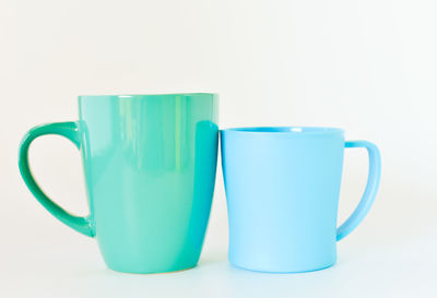 Close-up of blue cup against white background