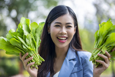 Portrait of a smiling young woman holding ice cream