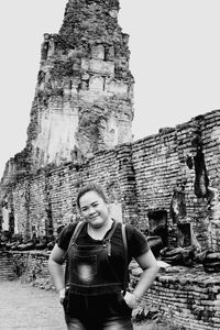 Portrait of woman standing outside temple