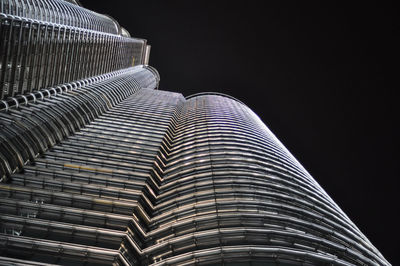 Low angle view of illuminated building against sky at night