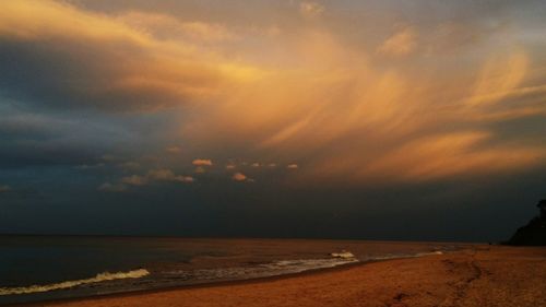 Scenic view of beach against sky during sunset