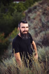 Portrait of a man with a beard on the background of nature
