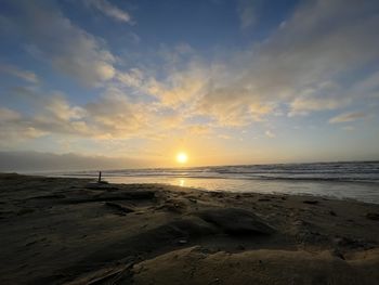 Scenic view of beach against sky during sunset