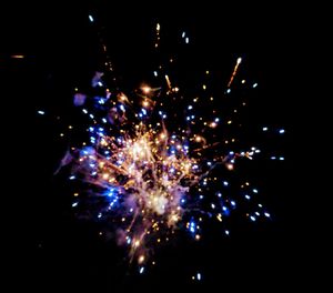 Low angle view of firework display at night