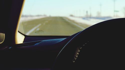 Close-up of car on road