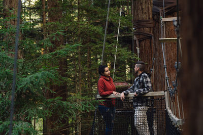Young couple sitting in forest