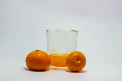 Close-up of orange fruit against white background