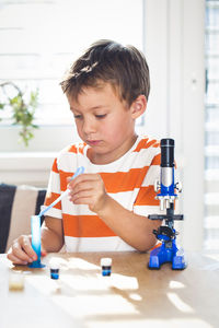 Boy doing science experiment at home