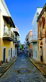 Empty alley amidst buildings in city