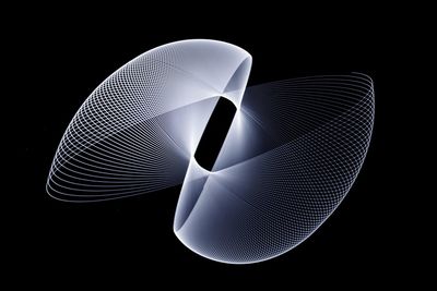 Close-up of illuminated lighting equipment against black background