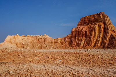 Rock formations in desert against sky