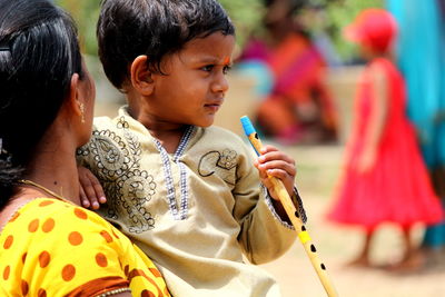 Boy with mother holding flute