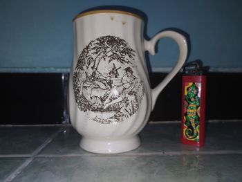 Close-up of coffee cup on table at home