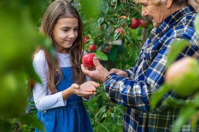 Portrait of young woman holding apple