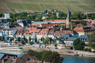 High angle view of townscape by river in city