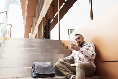 Handsome young man dressed casually spending time outdoors with