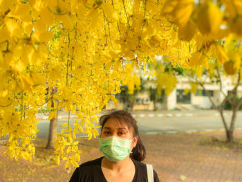 Portrait of woman on yellow flowering plants