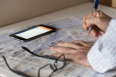 Cropped image of businessman doing paperwork at desk