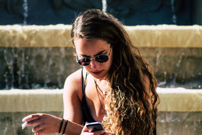 Portrait of young woman wearing sunglasses