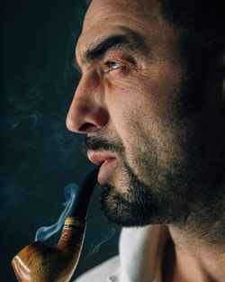 Close-up of mature man smoking cigarette