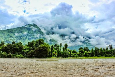 Scenic view of mountains against cloudy sky