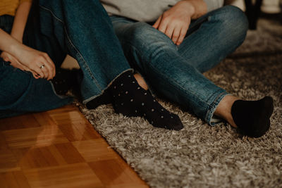 Low section of man sitting on floor at home