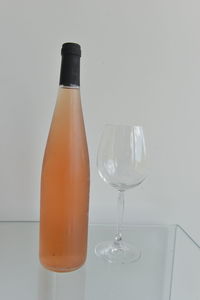 Close-up of wine glass on table against white background