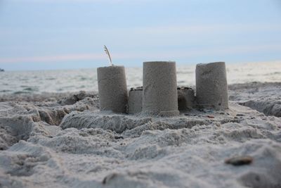 Close-up of sand on beach against sky