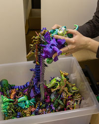 Cropped hand of woman holding potted plant