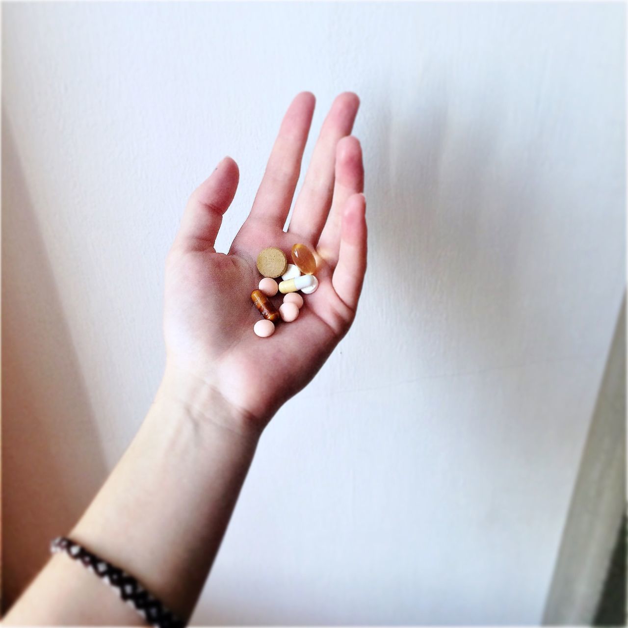 person, part of, human finger, holding, personal perspective, cropped, indoors, close-up, unrecognizable person, freshness, showing, flower, lifestyles, studio shot, white background, palm