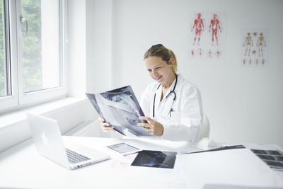 Full length of woman working on table