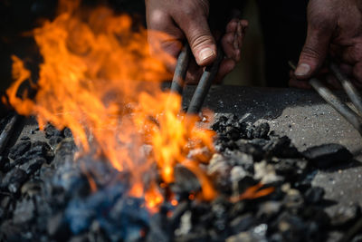 Midsection of man holding bonfire