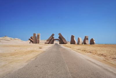 Panoramic view of desert against clear blue sky